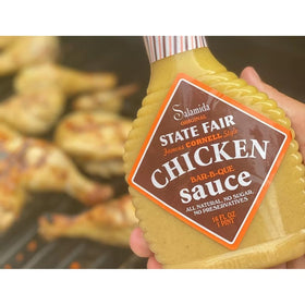 Rob Salamida bottle being poured on chicken for easy marinating and juicy outcomes.