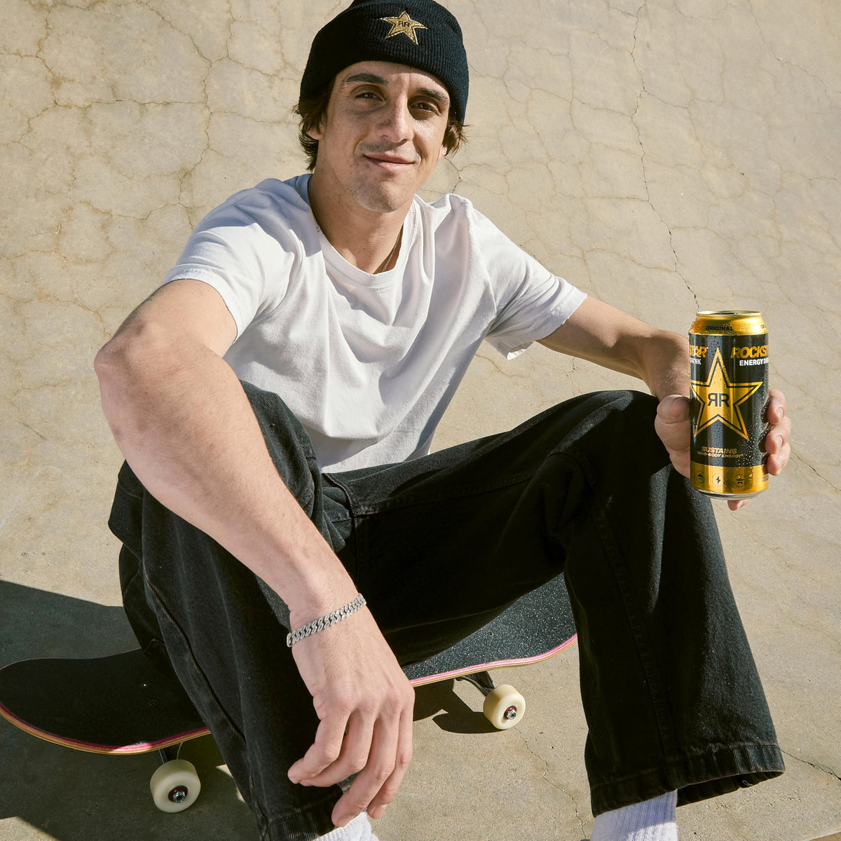 Athlete on the go reaching for Rockstar Original Energy to power training.