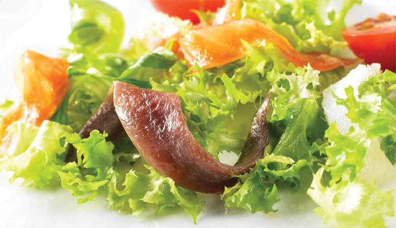 Roland Foods anchovies in olive oil close-up for premium flavor in dressings.