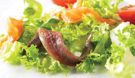 Roland Foods anchovies in olive oil close-up for premium flavor in dressings.