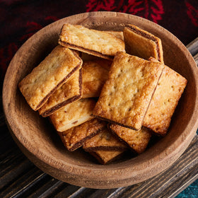 Rooted In Rare graham flour on counter next to recipe ideas for wholesome baking.