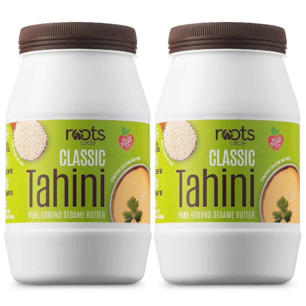 Roots Circle sesame tahini paste creamy texture on a spoon for smooth hummus