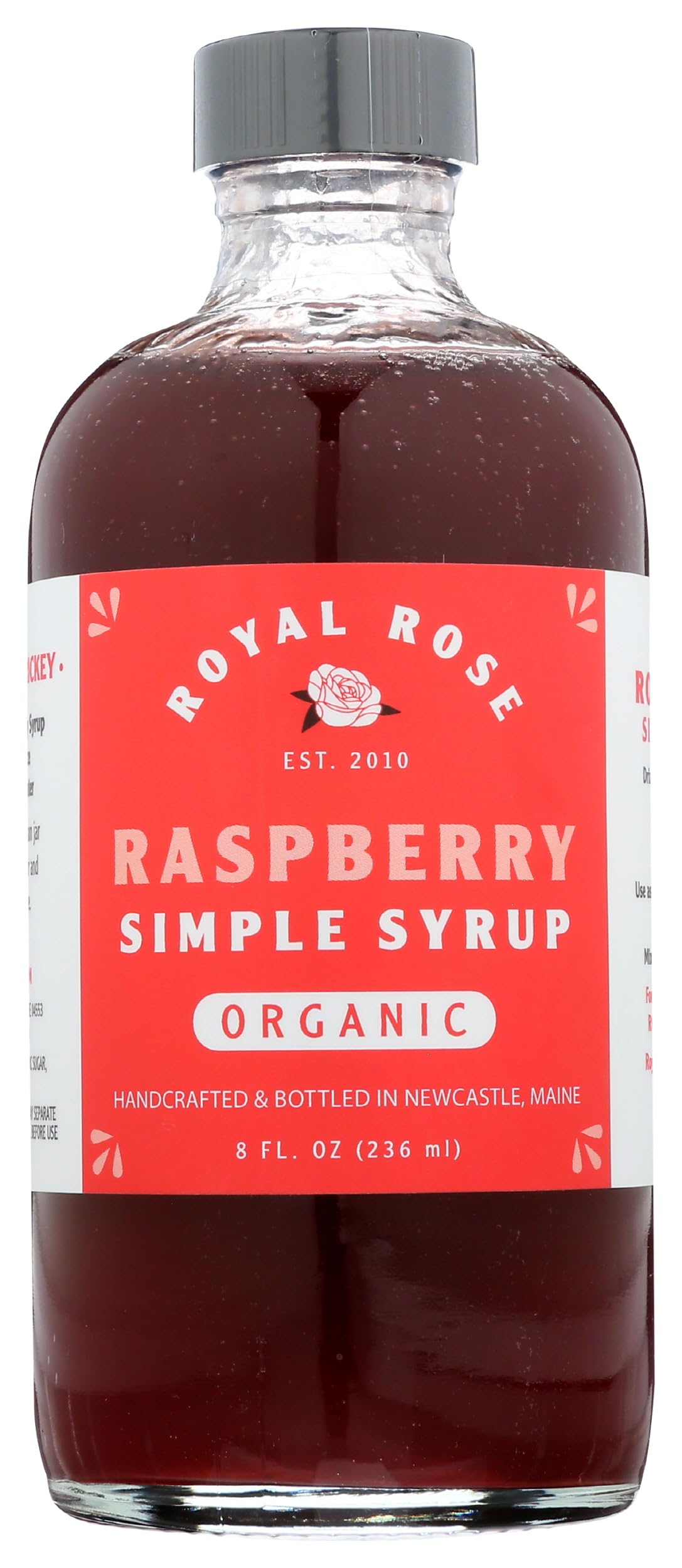 Royal Rose Organic Raspberry Simple Syrup bottle on counter, ideal for cocktails and toppings.