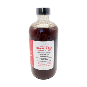 Royal Rose Raspberry Syrup bottle on wooden counter ready for desserts.