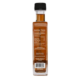 Pouring Runamok maple syrup over pancakes to enhance breakfast.