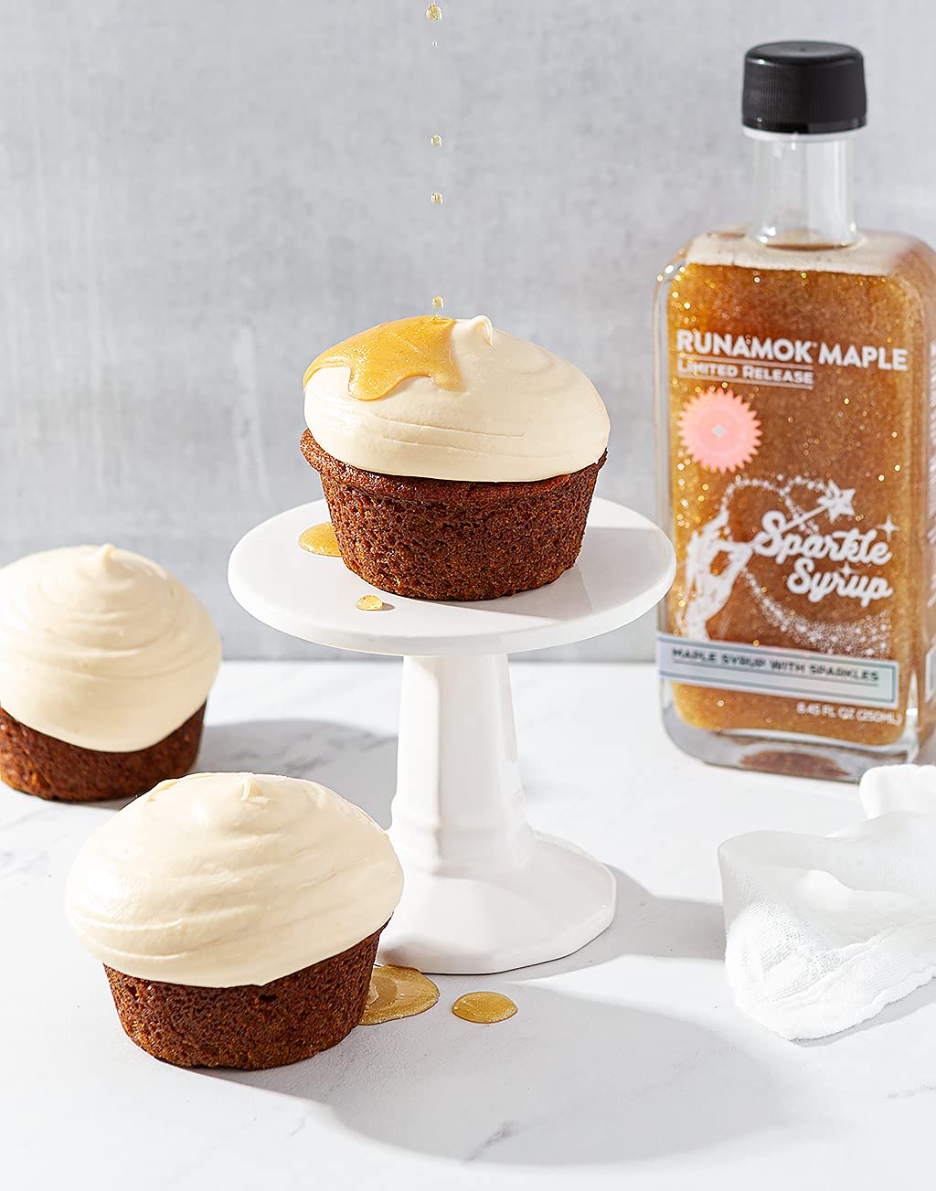 Pouring Runamok Sparkle Syrup over pancakes for a sparkling finish