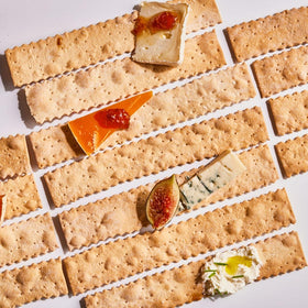 Rustic Bakery crackers on a cheese board pair well with soft and hard cheeses