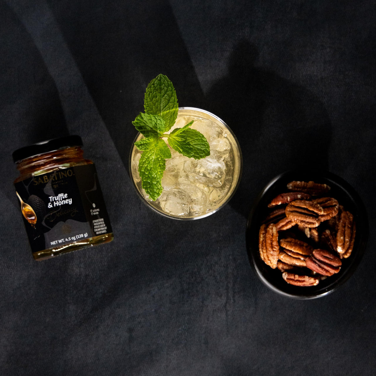 Sabatino Tartufi Truffle Honey on a cheese board highlighting savory-sweet balance