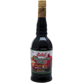 Sadaf Pomegranate Sour Paste Molasses bottle pour highlights rich, tangy flavor for marinades.