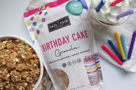 Safe + Fair Birthday Cake Granola packaging next to smoothie.