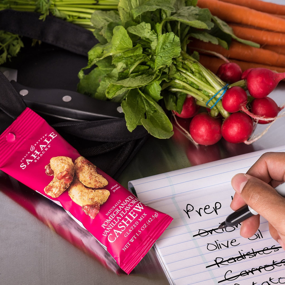 Cashews and pomegranate-infused apples on a colorful pouch promote easy eating.