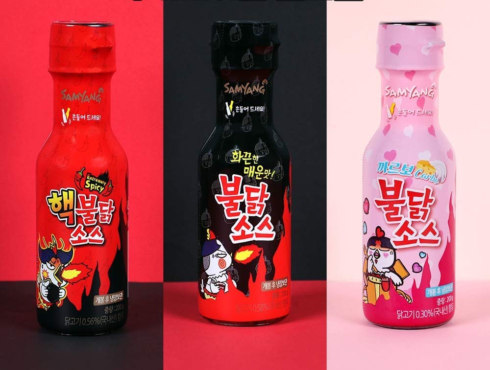 Samyang Carbo Bulldark sauce packaging on display shows a spicy sauce trio.