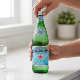 Family dinner setup with San Pellegrino 6-pack bottles at the table.