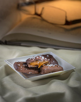 Sanders Milk Chocolate Sea Salt Caramel Thins tub packaging emphasizes gift-worthy presentation and sharing.