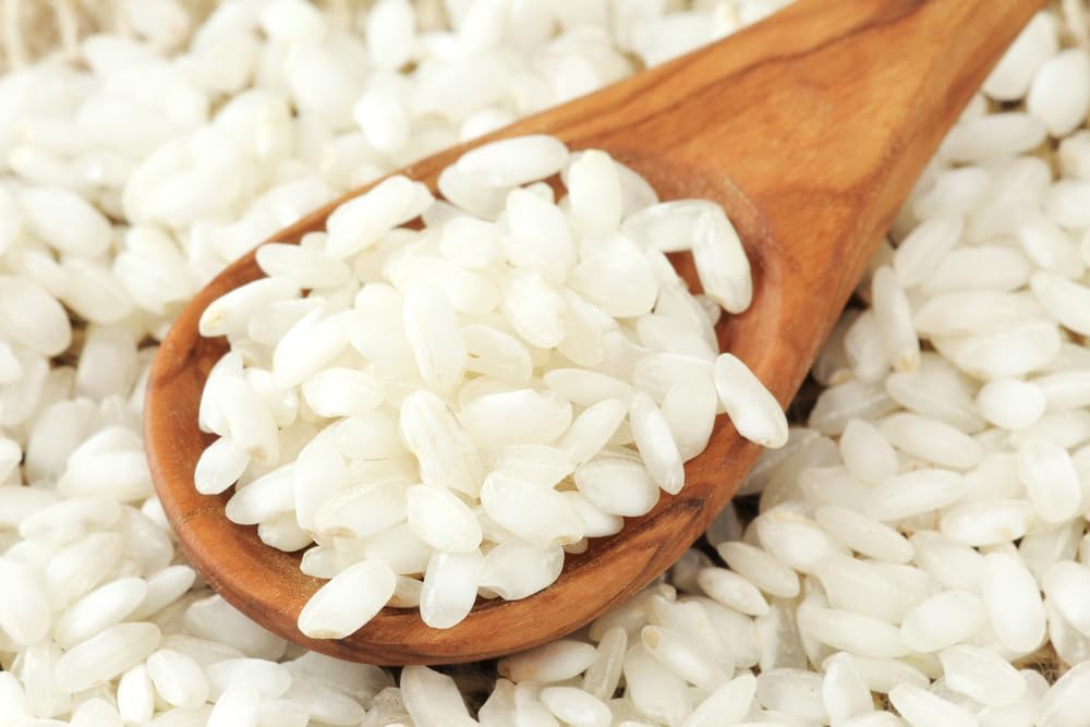 Sanniti Arborio Rice cooking process with gradual stock addition.