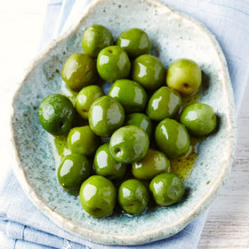Sanniti Castelvetrano jar label close-up highlights green plump olives.