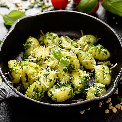 Sanniti cooking gnocchi dish sizzling in skillet.