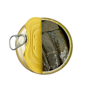 Sanniti Dolmas slices on a wooden board for an appetizer spread.