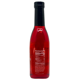 Sanniti Maraschino Cherry Syrup being poured into a glass to enhance cocktails