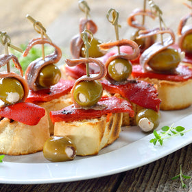 Sanniti olive jars and snack pack on table for guests.