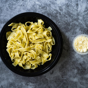 Sanniti pappardelle on a wooden board for homestyle plating.
