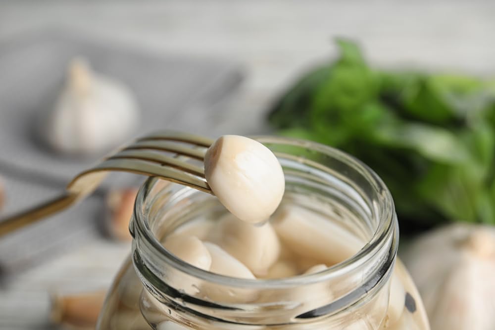 Sanniti garlic jars with olives on a rustic board for entertaining