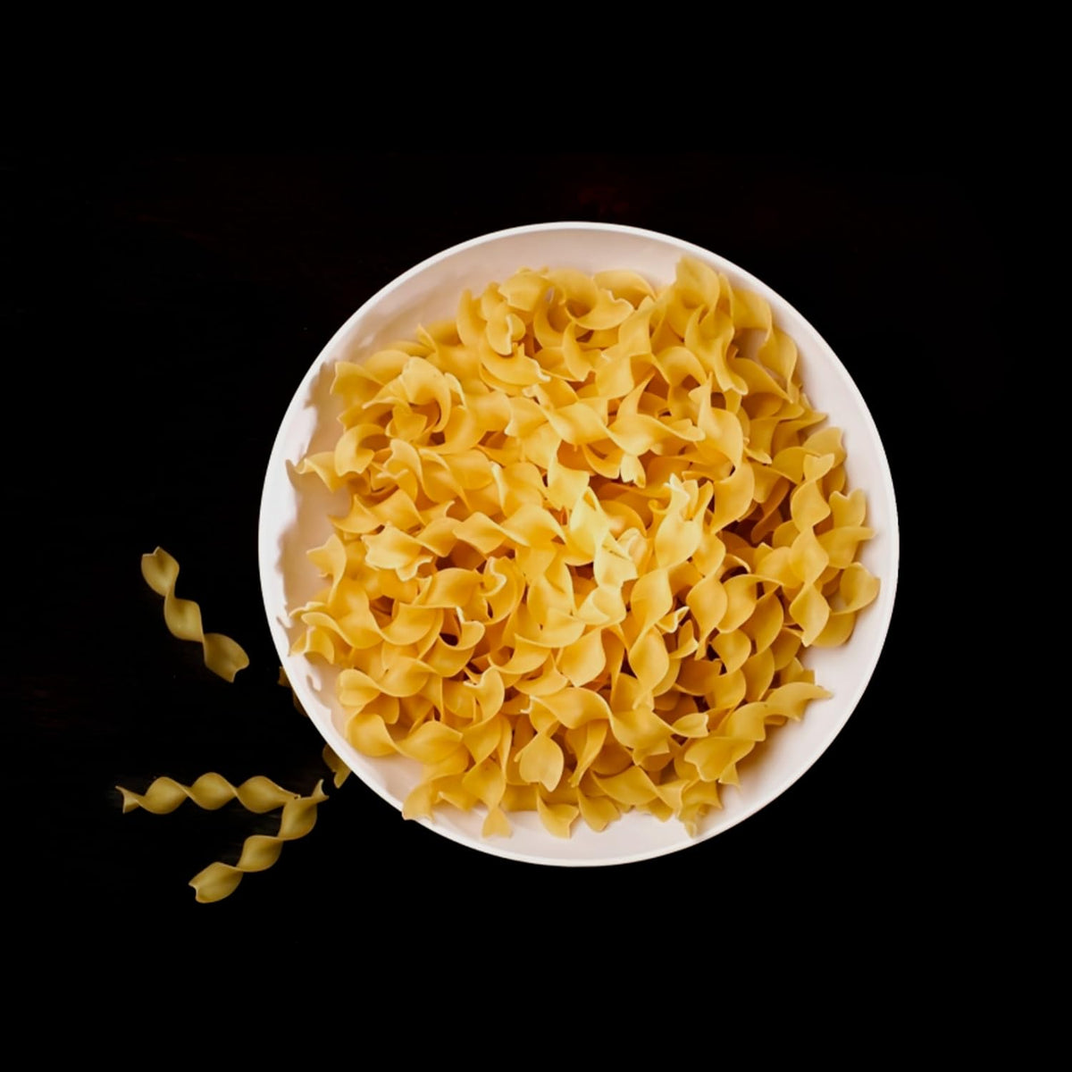 Sanniti prepared pasta plated with fresh herbs and olive oil.