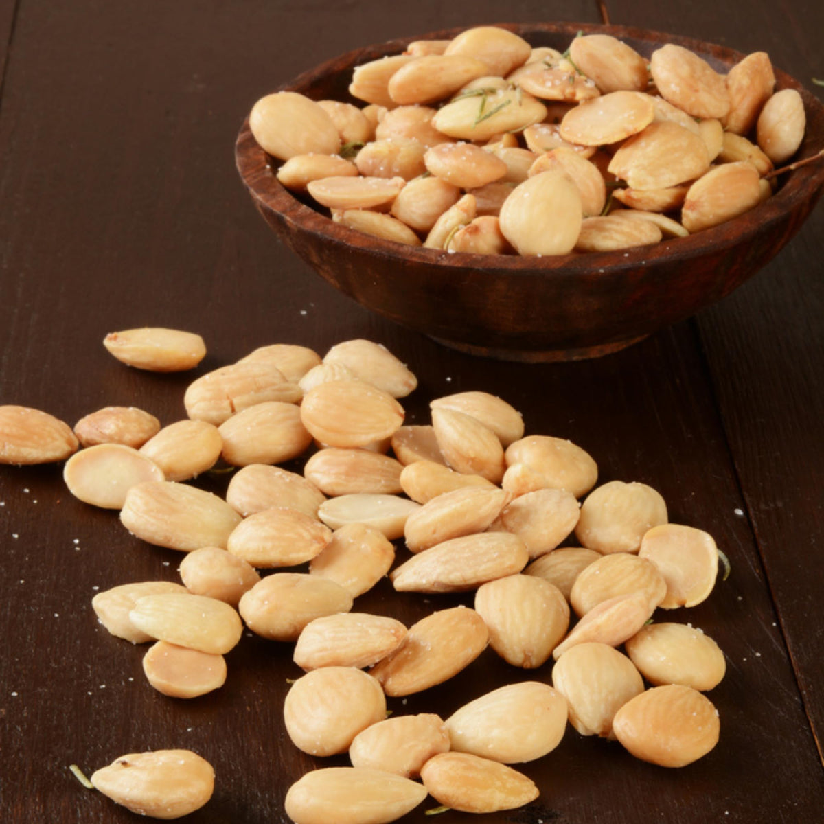 Sanniti Spanish Marcona almonds pouring from bag, ready to snack.