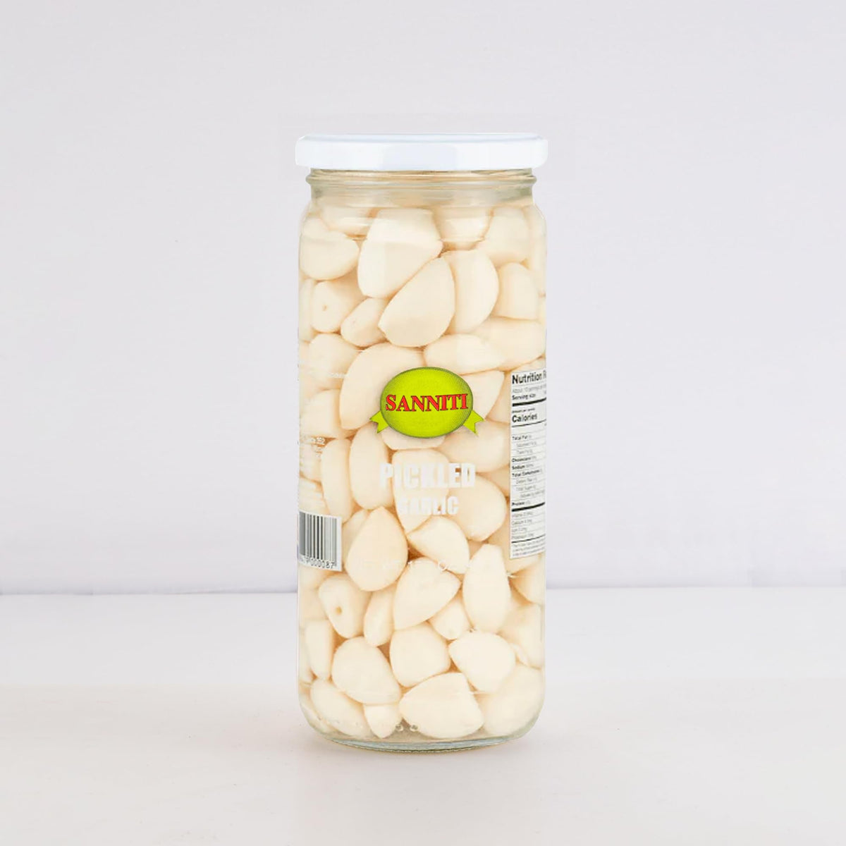 Sanniti Spanish Pickled Garlic open jar with sliced cloves for garnishes
