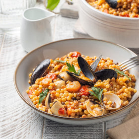 Sanniti fregola in a sauce pot demonstrates sauce clinging beads