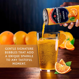 Sanpellegrino Aranciata served with orange slice in glass for gatherings.