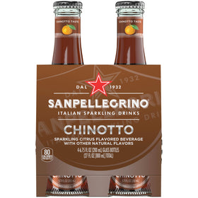 Sanpellegrino Chinotto bottle 4-pack on table, delivering a refreshing citrus moment.
