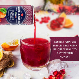 Sanpellegrino Melograno Arancia bottle and orange slice garnish, perfect for entertaining.