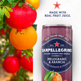 Sanpellegrino Melograno Arancia glass with garnish, ideal for pairing with meals.