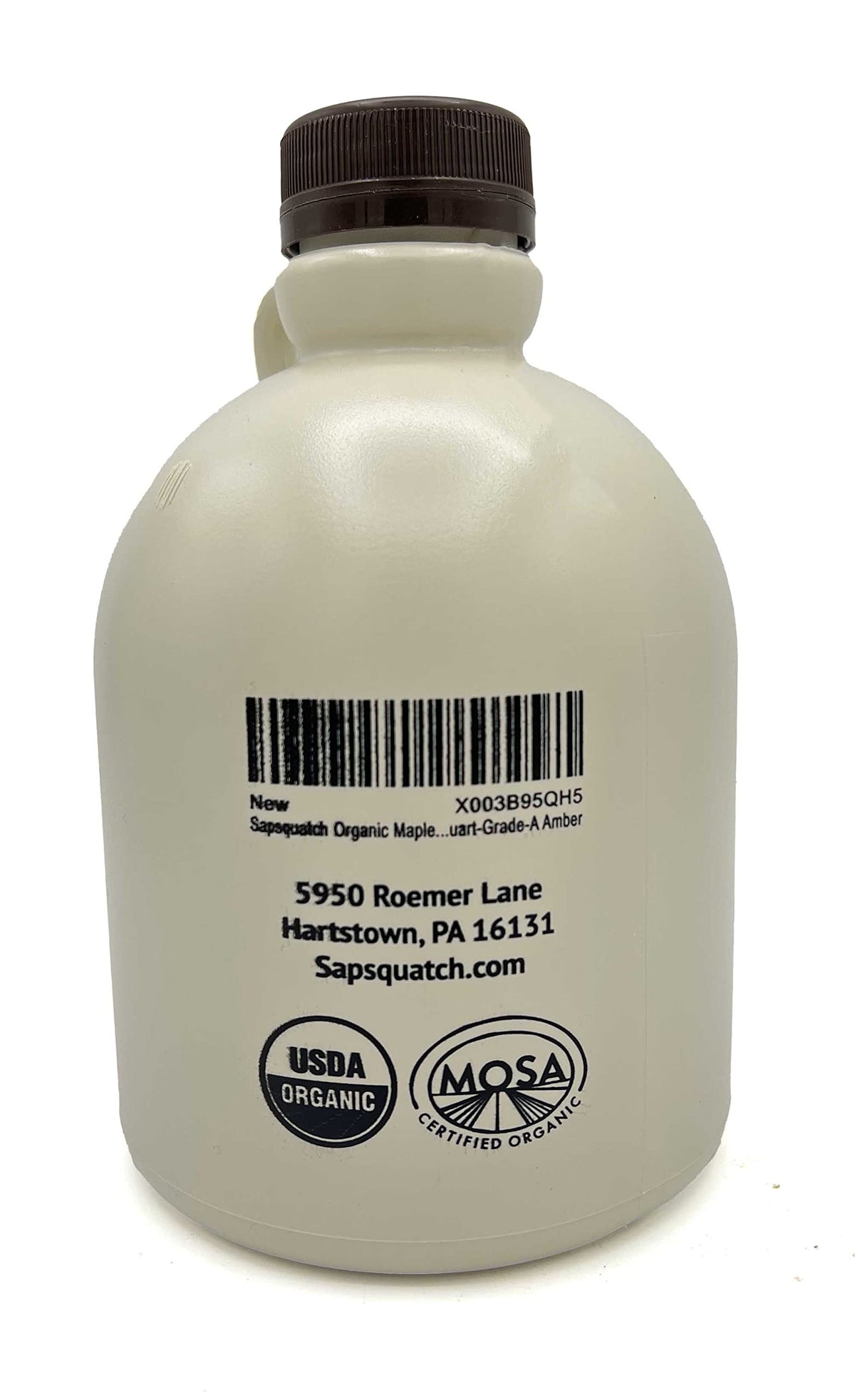 Sapsquatch Maple Syrup bottle beside pancakes, enhancing breakfast flavor