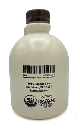 Sapsquatch Maple Syrup bottle beside pancakes, enhancing breakfast flavor