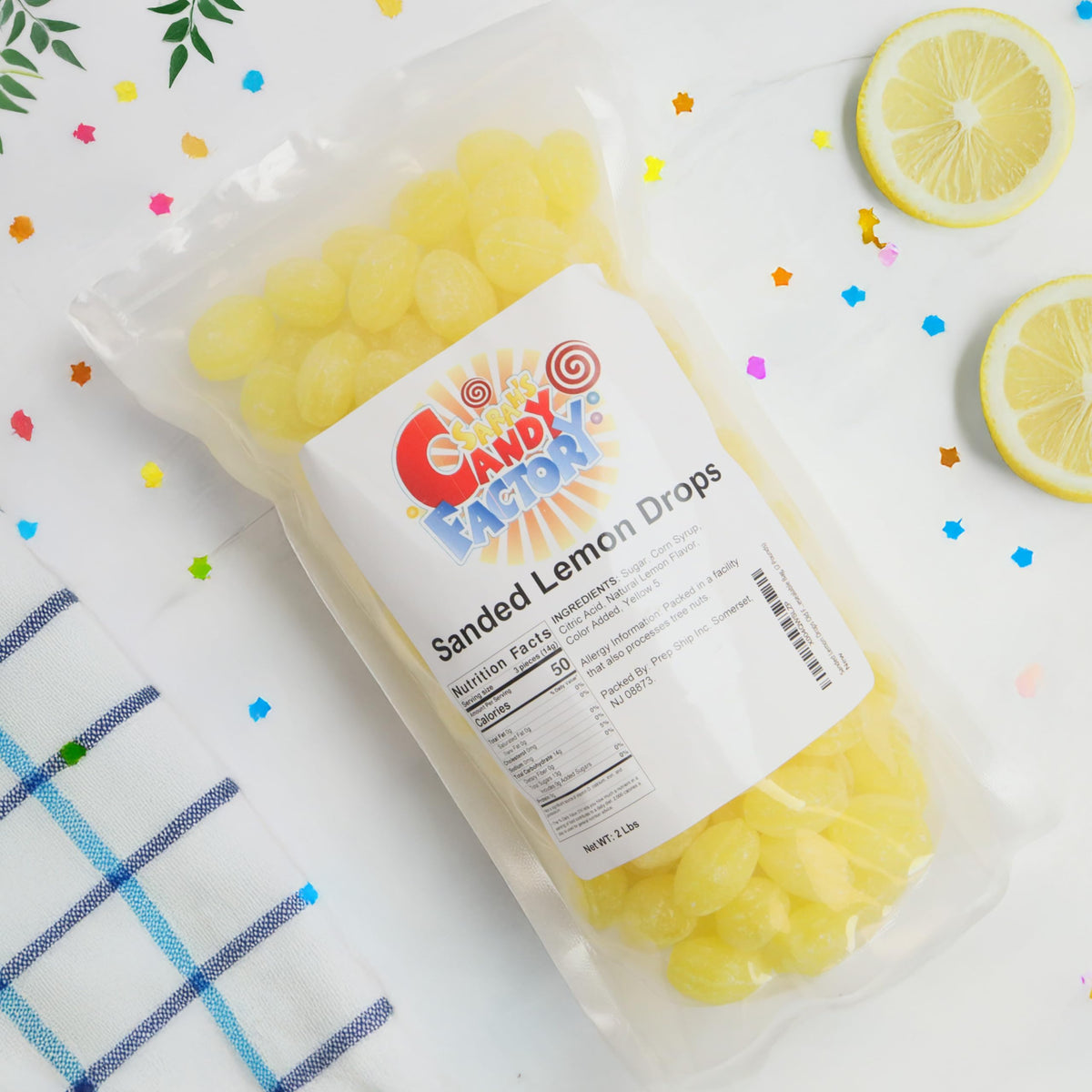 Close-up of lemon candies with sugar dust for a zesty bite by Sarah's Candy Factory.