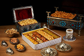 Sarah's Candy Factory baklava served with hot beverage enhances dessert moments.