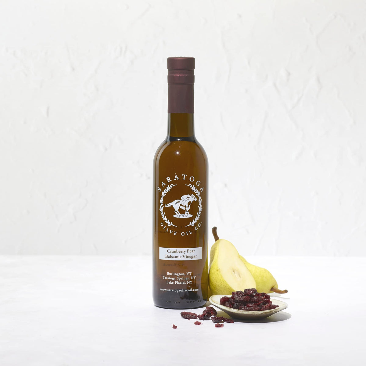 Saratoga Cranberry Pear White Balsamic bottle shows rose blush, ideal as a salad glaze.