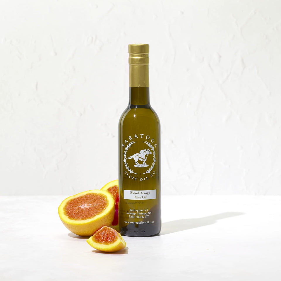 Saratoga Olive Oil Co Blood Orange bottle being poured for seafood flavor