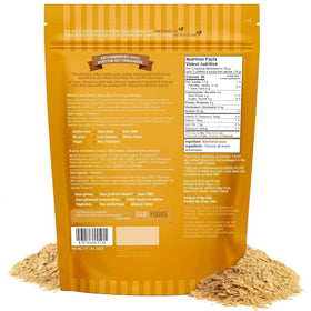 Sari Foods Co Non Fortified Nutritional Yeast Flakes with a spoon for easy topping and flavor.