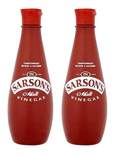 Sarsons Malt Vinegar 300ml bottle pour captured mid-pour, perfect for sauces and marinades.