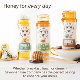 Savannah Bee Company honey in a glass jar with amber glow.