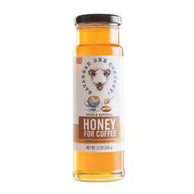 Savannah Bee coffee honey poured from glass bottle for rich sweetness.