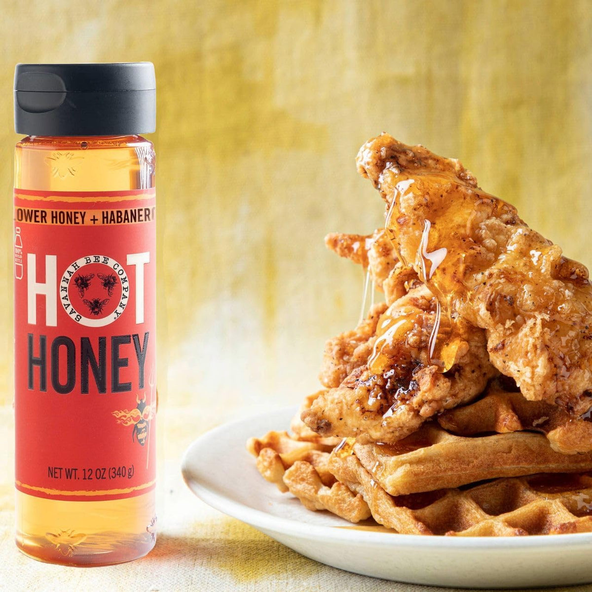 Savannah Bee hot honey on a cheese board for pairing with crackers.