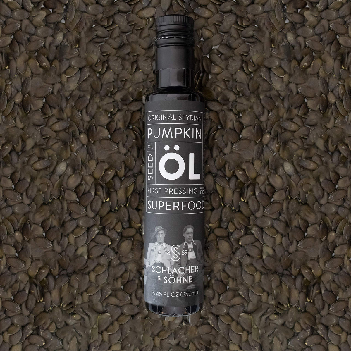 Schlacher & Söhne Styrian Pumpkin Seed Oil on a spoon showcasing rich texture.