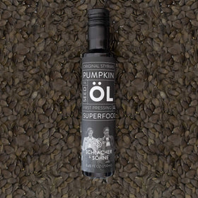 Schlacher & Söhne Styrian Pumpkin Seed Oil on a spoon showcasing rich texture.