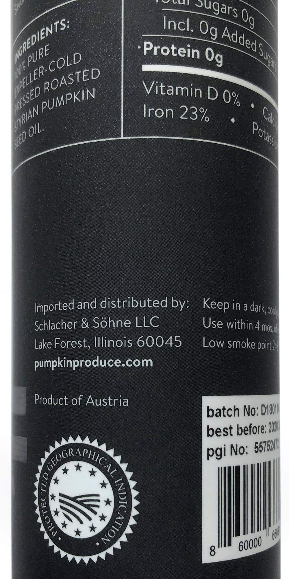 Schlacher & Söhne Styrian Pumpkin Seed Oil being poured over a fresh salad.