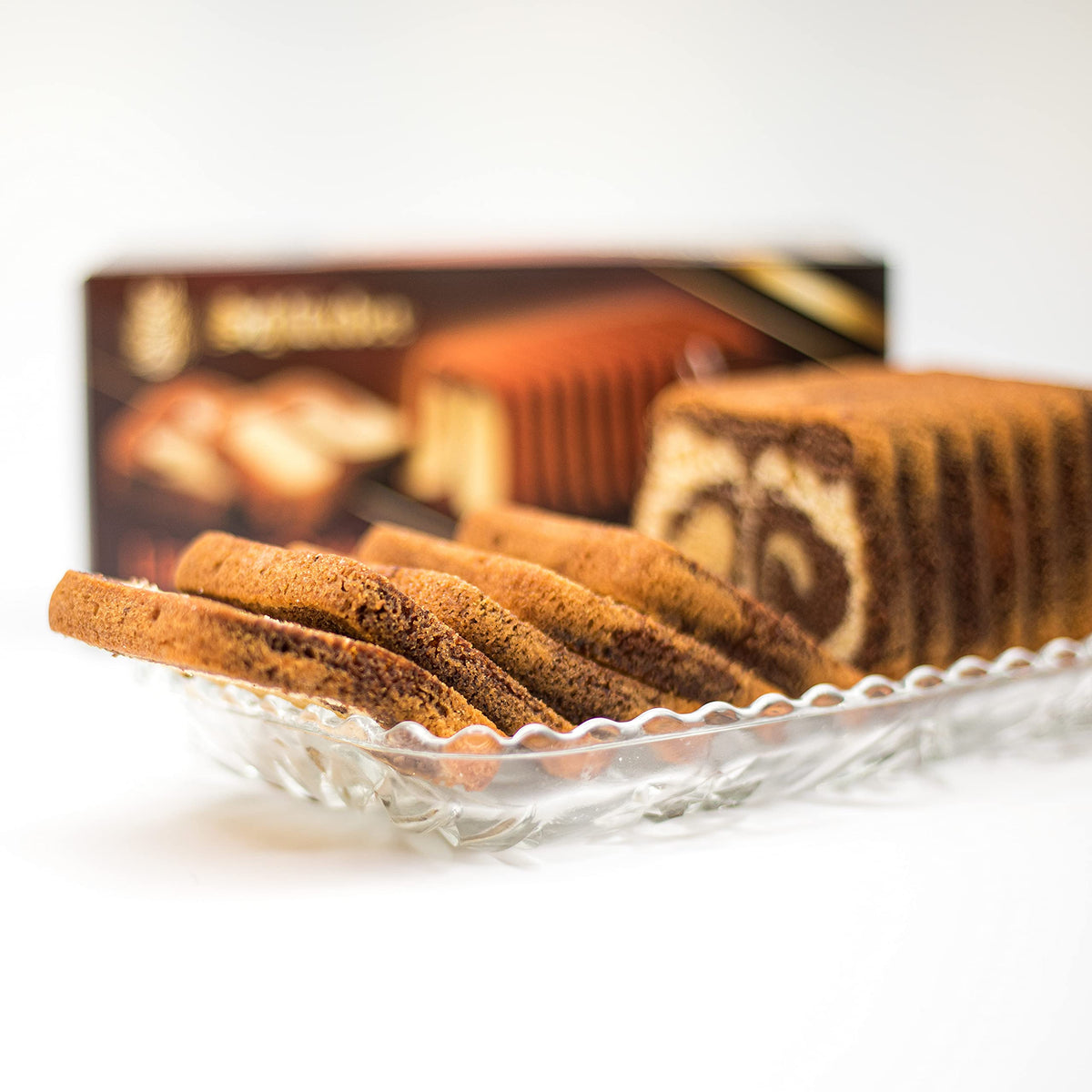 Schlunder Cappuccino Cake beside a coffee cup, perfect after-dinner pairing.