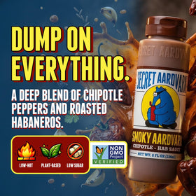 Secret Aardvark Smoky Chipotle Hot Sauce bottle pouring adds spice to grilled meats and vegetables.